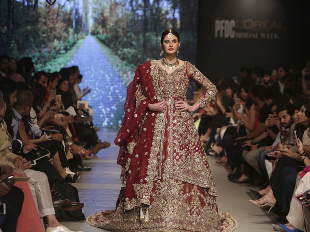 A model presents a creation of designer Nicke Nina during the Bridal Fashion Week organized by the Pakistan Fashion Design Council, in Lahore, Pakistan. Photo: AP A model presents a creation of designer Nicke Nina during the Bridal Fashion Week organized by the Pakistan Fashion Design Council, in Lahore, Pakistan. Photo: AP