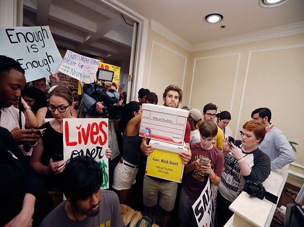 People crowd the entrance to the office of Florida Gov. Rick Scott with boxes of petitions for gun control reform, after a rally on the steps of the state Capitol in Tallahassee. (Image: AP) People crowd the entrance to the office of Florida Gov. Rick Scott with boxes of petitions for gun control reform, after a rally on the steps of the state Capitol in Tallahassee. (Image: AP)