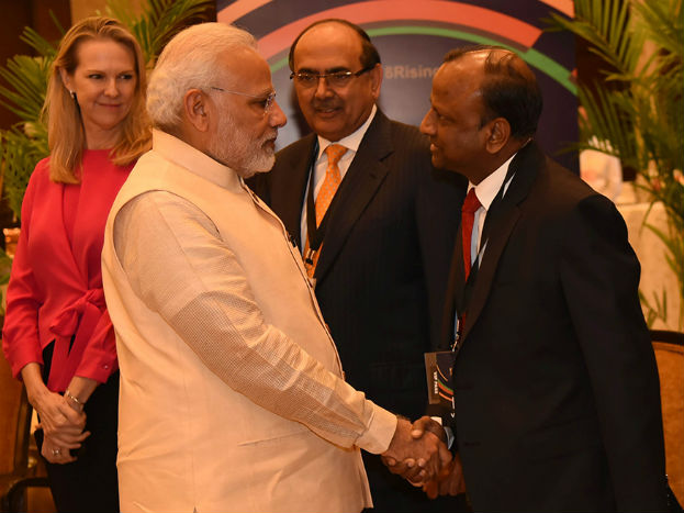 Chairman of State Bank of India, Rajnish Kumar and PM Narendra Modi exchange greetings at the News18 Rising India Summit held in New Delhi on March 16, 2018 (Photo: News18) Chairman of State Bank of India, Rajnish Kumar and PM Narendra Modi exchange greetings at the News18 Rising India Summit held in New Delhi on March 16, 2018 (Photo: News18)
