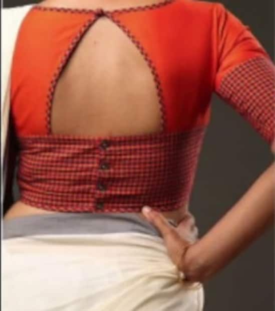 উঁচু গলা, পিঠে ত্রিকোনাকৃতি। গ্লাসস্লিভ। কনট্রাস্ট এফেক্ট আনতে হাতা ও কোমরে কালো চেক কাপড়ের পট্টি বসানো হয়েছে।  Photo Source : youtube