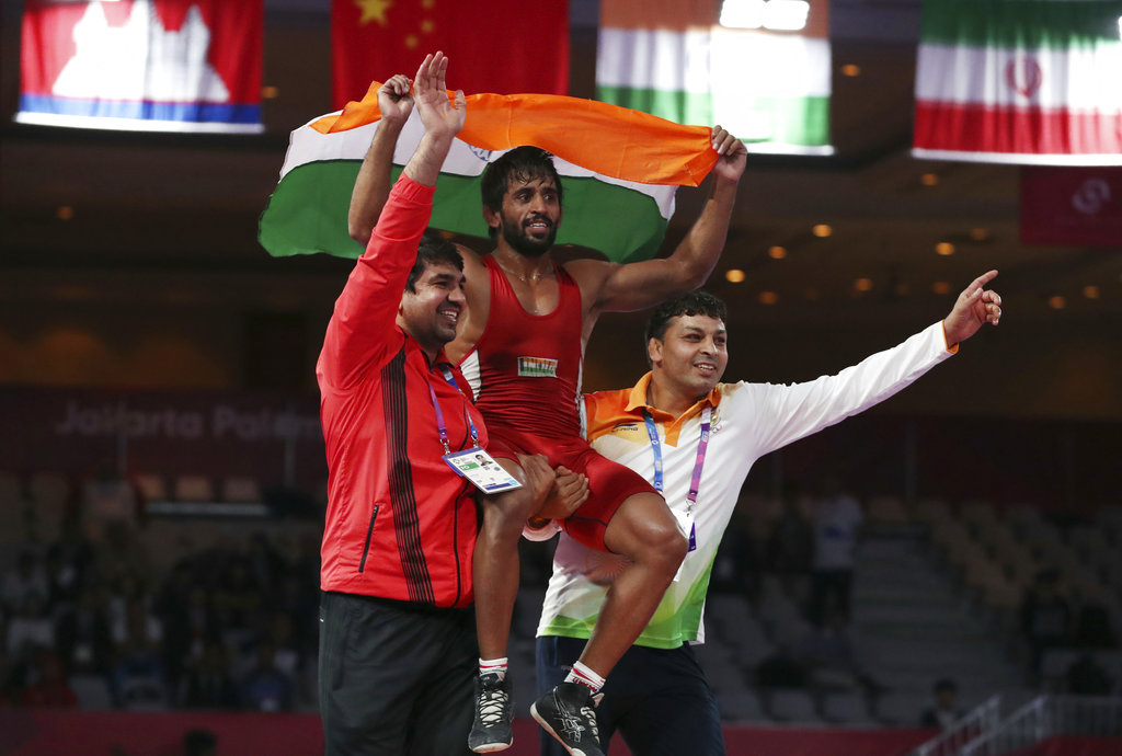 কিন্তু শেষ পর্যন্ত স্নায়ূর চাপ সামলে বাজিমাত করলেন বজরংই। ফাইনাল ম্যাচটি তিনি জিতলেন ১১-৮ পয়েন্টের ব্যবধানে। (Image: AP) কিন্তু শেষ পর্যন্ত স্নায়ূর চাপ সামলে বাজিমাত করলেন বজরংই। ফাইনাল ম্যাচটি তিনি জিতলেন ১১-৮ পয়েন্টের ব্যবধানে। (Image: AP)