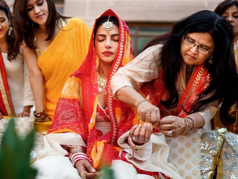 ♦ গায়ে হলুদের পর হয় প্রিয়াঙ্কার চুনরি ও চূড়া সেরিমনি ৷ লাল-হলুদ ওড়নায় মাথা ঢেকে তার হতে পরানো হয় চূড়া ৷ একে একে কলিরে বেঁধে দেন মা-কাকিমারা ৷ ছবি: ইনস্টাগ্রাম ৷