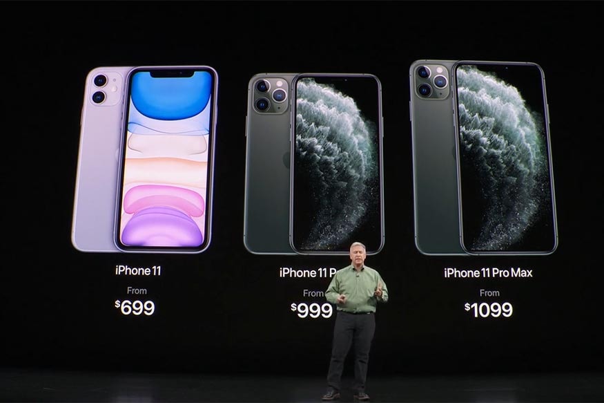 অপেক্ষার অবসান, মঙ্গলবার লঞ্চ হল iPhone 11 সিরিজ। কুপার্টিনোর স্টিভ জোবস থিয়েটারে একাধিক Apple প্রোডাক্ট ও সার্ভিসের সাথে লঞ্চ হয়েছে নতুন বাজেট আইফোন iPhone। ভারতে iPhone 11-এর দাম শুরু হচ্ছে 64,900 টাকা থেকে। iPhone 11 Pro-এর দাম শুরু হচ্ছে 99,900 টাকা থেকে আর Pro Max-এর দাম শুরু হচ্ছে 1,09,900 টাকা থেকে। (Image: Apple/News18.com) অপেক্ষার অবসান, মঙ্গলবার লঞ্চ হল iPhone 11 সিরিজ। কুপার্টিনোর স্টিভ জোবস থিয়েটারে একাধিক Apple প্রোডাক্ট ও সার্ভিসের সাথে লঞ্চ হয়েছে নতুন বাজেট আইফোন iPhone। ভারতে iPhone 11-এর দাম শুরু হচ্ছে 64,900 টাকা থেকে। iPhone 11 Pro-এর দাম শুরু হচ্ছে 99,900 টাকা থেকে আর Pro Max-এর দাম শুরু হচ্ছে 1,09,900 টাকা থেকে। (Image: Apple/News18.com)