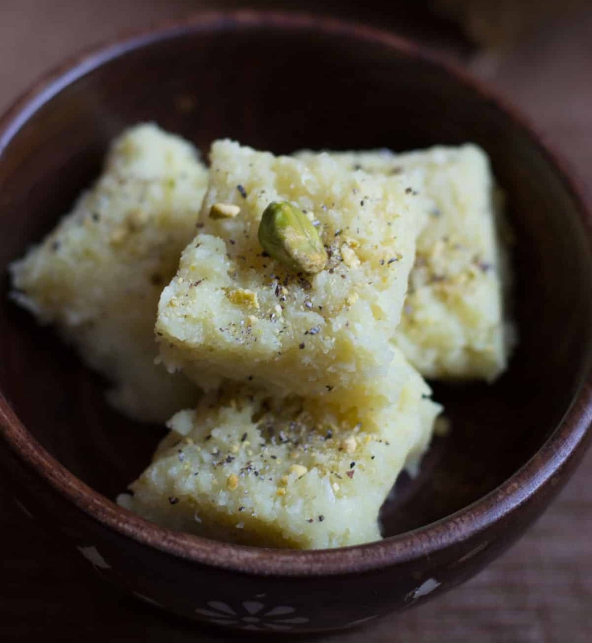 নারকেলের বরফি: উপকরণ: ২ কাপ নারকেল কোরা, ২ কাপ চিনি, ১ টেবিল-চামচ ঘি, ১/২ টেবিল-চামচ কাজুকুচি, ১/২ চামচ এলাচগুঁড়ো | প্রণালী: কড়ায় ঘি গরম করে কাজু সোনালি করে ভেজে নিন। এ বার ওই কড়াতেই নারকেল কোরা আর চিনি দিয়ে নাড়তে থাকুন। নারকেল থেকে যতক্ষণ না জল বেরিয়ে পুরো শুকিয়ে যাচ্ছে, ততক্ষণ নাড়তে হবে। এ বার কাজুকুচি আর এলাচগুঁড়ো দিয়ে নাড়তে থাকুন। কোরার রং একটু গাঢ় হয়ে এলে নামিয়ে নিন। একটা থালায় ঘি মাখিয়ে তার উপরে ওই নারকেল কোরা রেখে বরফির আকারে কেটে পরিবেশন করুন। নারকেলের বরফি: উপকরণ: ২ কাপ নারকেল কোরা, ২ কাপ চিনি, ১ টেবিল-চামচ ঘি, ১/২ টেবিল-চামচ কাজুকুচি, ১/২ চামচ এলাচগুঁড়ো | প্রণালী: কড়ায় ঘি গরম করে কাজু সোনালি করে ভেজে নিন। এ বার ওই কড়াতেই নারকেল কোরা আর চিনি দিয়ে নাড়তে থাকুন। নারকেল থেকে যতক্ষণ না জল বেরিয়ে পুরো শুকিয়ে যাচ্ছে, ততক্ষণ নাড়তে হবে। এ বার কাজুকুচি আর এলাচগুঁড়ো দিয়ে নাড়তে থাকুন। কোরার রং একটু গাঢ় হয়ে এলে নামিয়ে নিন। একটা থালায় ঘি মাখিয়ে তার উপরে ওই নারকেল কোরা রেখে বরফির আকারে কেটে পরিবেশন করুন।