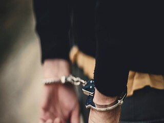 Man in handcuffs behind his back
