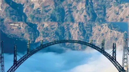 Union Minister Ashwini Vaishnaw on Monday shared picture of the of the arch of the world's highest railway bridge, the Chenab Bridge. “The world's highest #arch #ChenabBridge over the clouds,” he wrote. (Image: Twitter/Ashwini Vaishnaw) Union Minister Ashwini Vaishnaw on Monday shared picture of the of the arch of the world's highest railway bridge, the Chenab Bridge. “The world's highest #arch #ChenabBridge over the clouds,” he wrote. (Image: Twitter/Ashwini Vaishnaw)