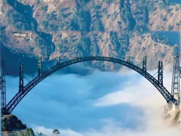 Union Minister Ashwini Vaishnaw on Monday shared picture of the of the arch of the world's highest railway bridge, the Chenab Bridge. “The world's highest #arch #ChenabBridge over the clouds,” he wrote. (Image: Twitter/Ashwini Vaishnaw)