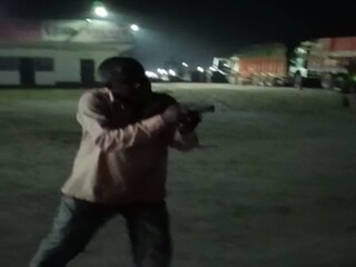 Man shows gun as one person 