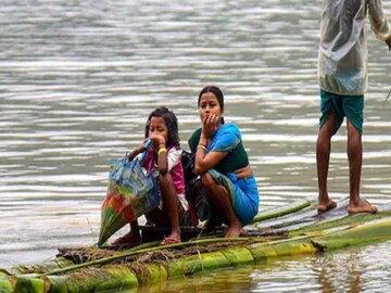Villagers use a makeshift boat to move to a safer place from a flood-affected area following heavy rainfall in Goalpara district. (Image: News18)