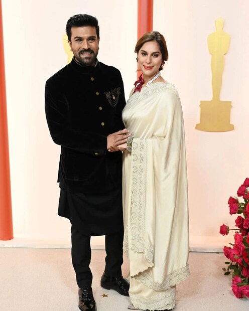 অস্কারের রেড কার্পেটে পোজ দিচ্ছেন রাম চরণ ও তাঁর স্ত্রী। (ছবি: ইনস্টাগ্রাম)