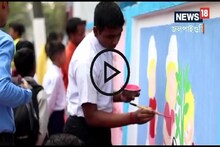 দোল খেলার সঙ্গী স্কুলের সীমানা প্রাচীর! তাকেই রাঙিয়ে দিল