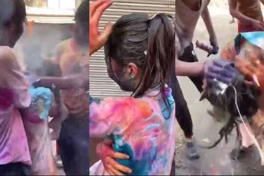 এ ভাবেই রং মাখানোর নামে হেনস্থা করা হয় ওই বিদেশিনিকে৷ ভিডিও থেকে নেওয়া স্ক্রিনশট৷ Photo-Twitter