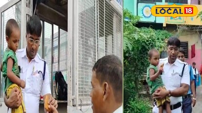 বাচ্চা কোলে পুলিশ 