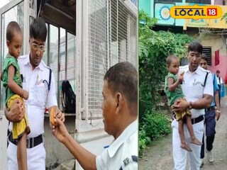 বাচ্চা কোলে পুলিশ 