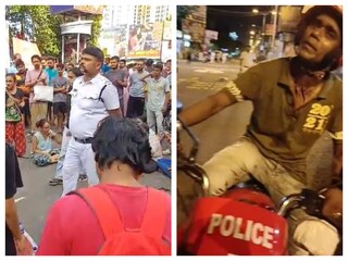 পুলিশ অফিসারকে ঘেরাও করে রেখেছেন বিক্ষোভকারীরা৷ অভিযুক্ত সিভিক ভলেন্টিয়ার (ডানদিকে)৷ 