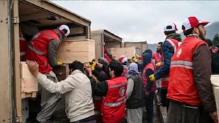 Afghan Red Crescent Society volunteers load coffins into ambulances after offering funeral prayers for victims of a Pakistani air strike on a drug rehabilitation centre, during a mass burial ceremony at the Badam Bagh Hilltop in Kabul on Wednesday. (Image: AFP)