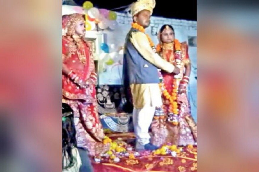 મધ્ય પ્રદેશના (Madhya Pradesh) ભિંડ જિલ્લાના મુખ્યાલયથી આશરે 30 કિલોમિટર દૂર એક ગામમાં એક વ્યક્તિએ કથિત રીતે પોતાની સરપંચ પત્ની (Sarpanch wife) અને પિતરાઈ બહેન સાથે એક જ મંડપમાં લગ્ન (Marriage) કર્યા હતા. મધ્ય પ્રદેશના (Madhya Pradesh) ભિંડ જિલ્લાના મુખ્યાલયથી આશરે 30 કિલોમિટર દૂર એક ગામમાં એક વ્યક્તિએ કથિત રીતે પોતાની સરપંચ પત્ની (Sarpanch wife) અને પિતરાઈ બહેન સાથે એક જ મંડપમાં લગ્ન (Marriage) કર્યા હતા.