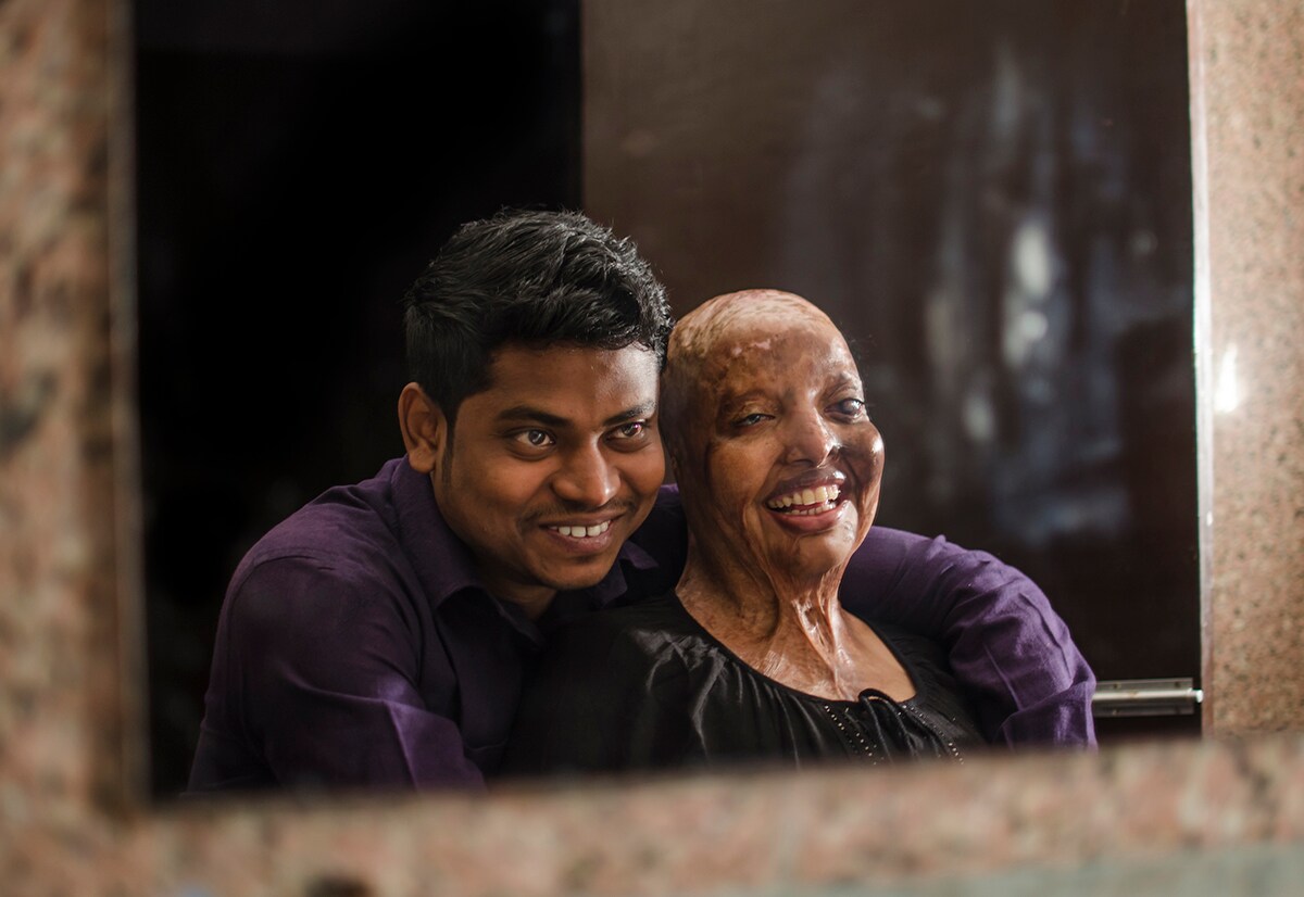 Reflection of true love. Couple sharing smiles while looking in the mirror.