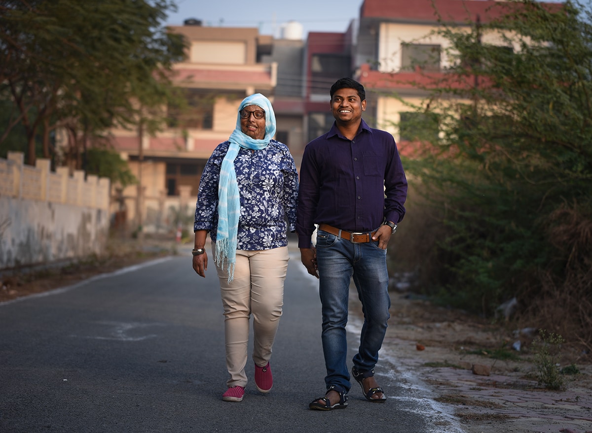 Couple walking down the street holding hands.
