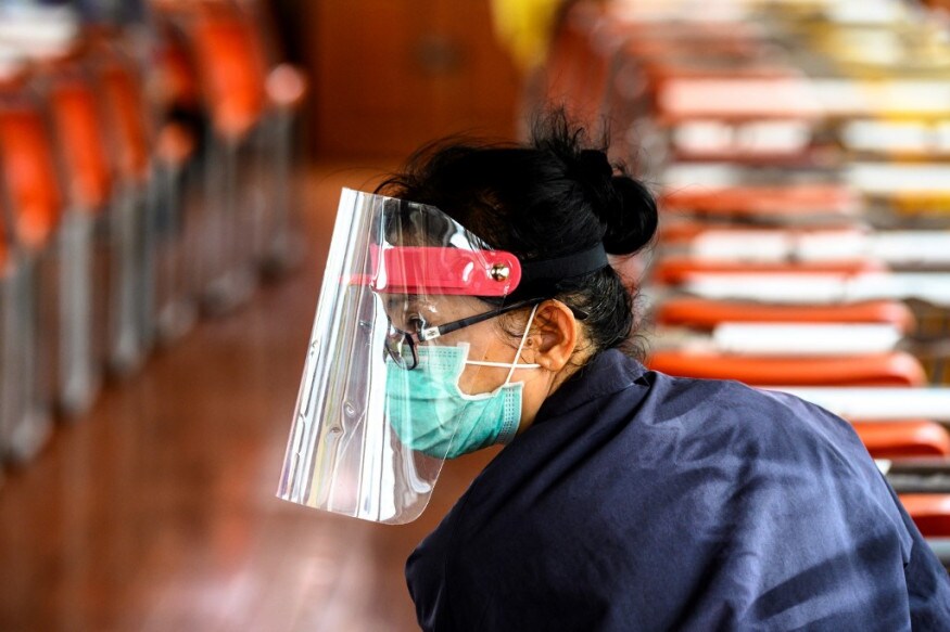 A passenger, wearing protective gear as a preventive measure against the spread of the COVID-19 novel coronavirus, rides a commuter boat on the Chao Phraya River in Bangkok. (Image: AFP) A passenger, wearing protective gear as a preventive measure against the spread of the COVID-19 novel coronavirus, rides a commuter boat on the Chao Phraya River in Bangkok. (Image: AFP)
