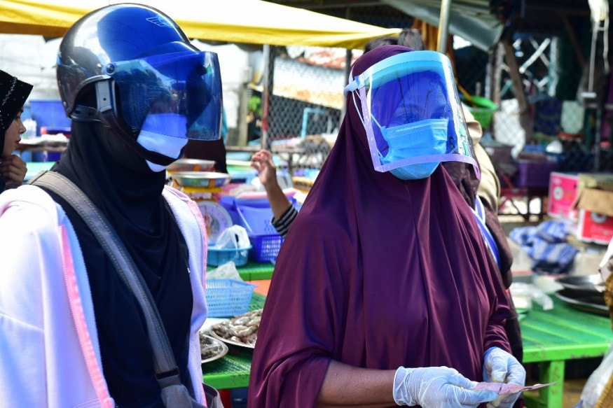 Women, wearing face masks as a preventive measure against the spread of the COVID-19 novel coronavirus, wait to buy seafood at a morning market in Thailand's southern province of Narathiwat. (Image: AFP) Women, wearing face masks as a preventive measure against the spread of the COVID-19 novel coronavirus, wait to buy seafood at a morning market in Thailand's southern province of Narathiwat. (Image: AFP)