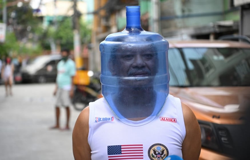 A resident using an improvised face shield made from a plastic water tank to protect him from the COVID-19 coronavirus pandemic walks in his neighbourhood in Manila. (Image: AFP) A resident using an improvised face shield made from a plastic water tank to protect him from the COVID-19 coronavirus pandemic walks in his neighbourhood in Manila. (Image: AFP)
