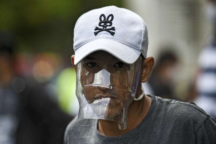 A Venezuelan migrant wears a plastic water bottle with a cutout to cover his face as he waits to be checked by health workers to rule out the novel coronavirus as part of his repatriation process in Cali, Colombia. (Image: AFP) A Venezuelan migrant wears a plastic water bottle with a cutout to cover his face as he waits to be checked by health workers to rule out the novel coronavirus as part of his repatriation process in Cali, Colombia. (Image: AFP)