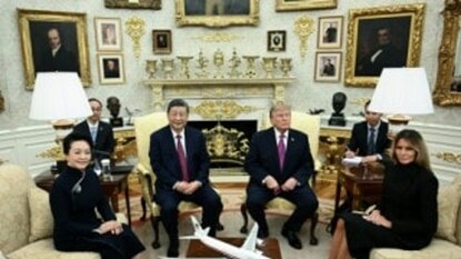 China's President Xi Jinping, alongside China's First Lady Peng Liyuan, and US President Donald Trump, alongside US First Lady Melania Trump, attend a bilateral meeting in the Oval Office of the White