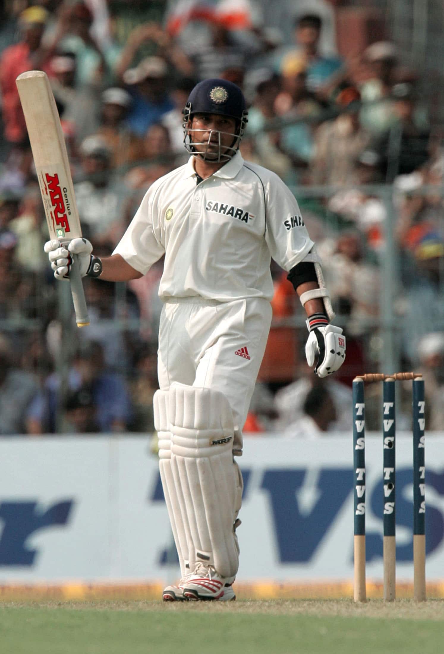 Indian batsman Sachin Tendulkar raises his bat to acknowledge the crowd in Calcutta.