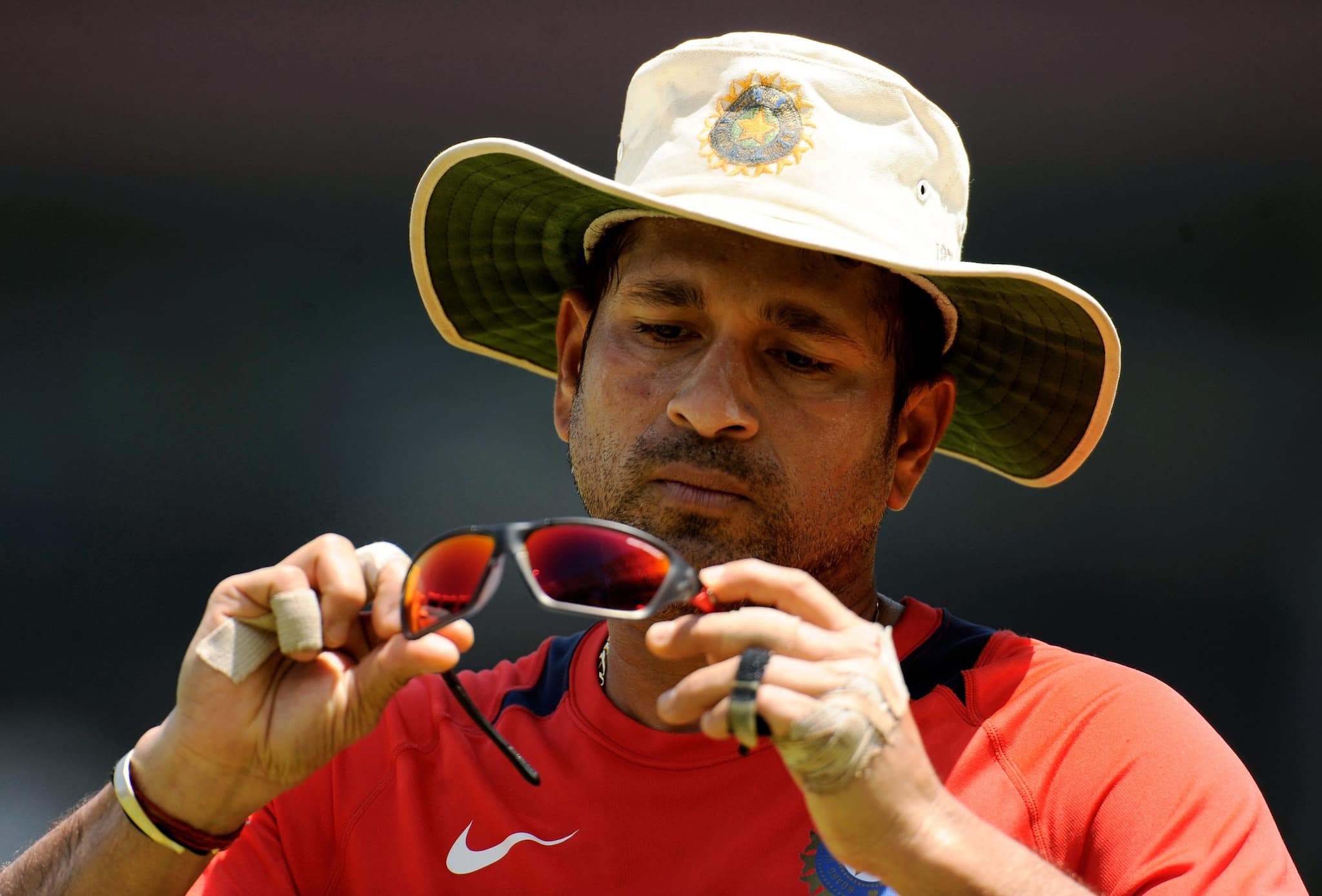 India's Sachin Tendulkar looks at his shades during a training session before their ICC Cricket World Cup Group B match against the West Indies in Chennai