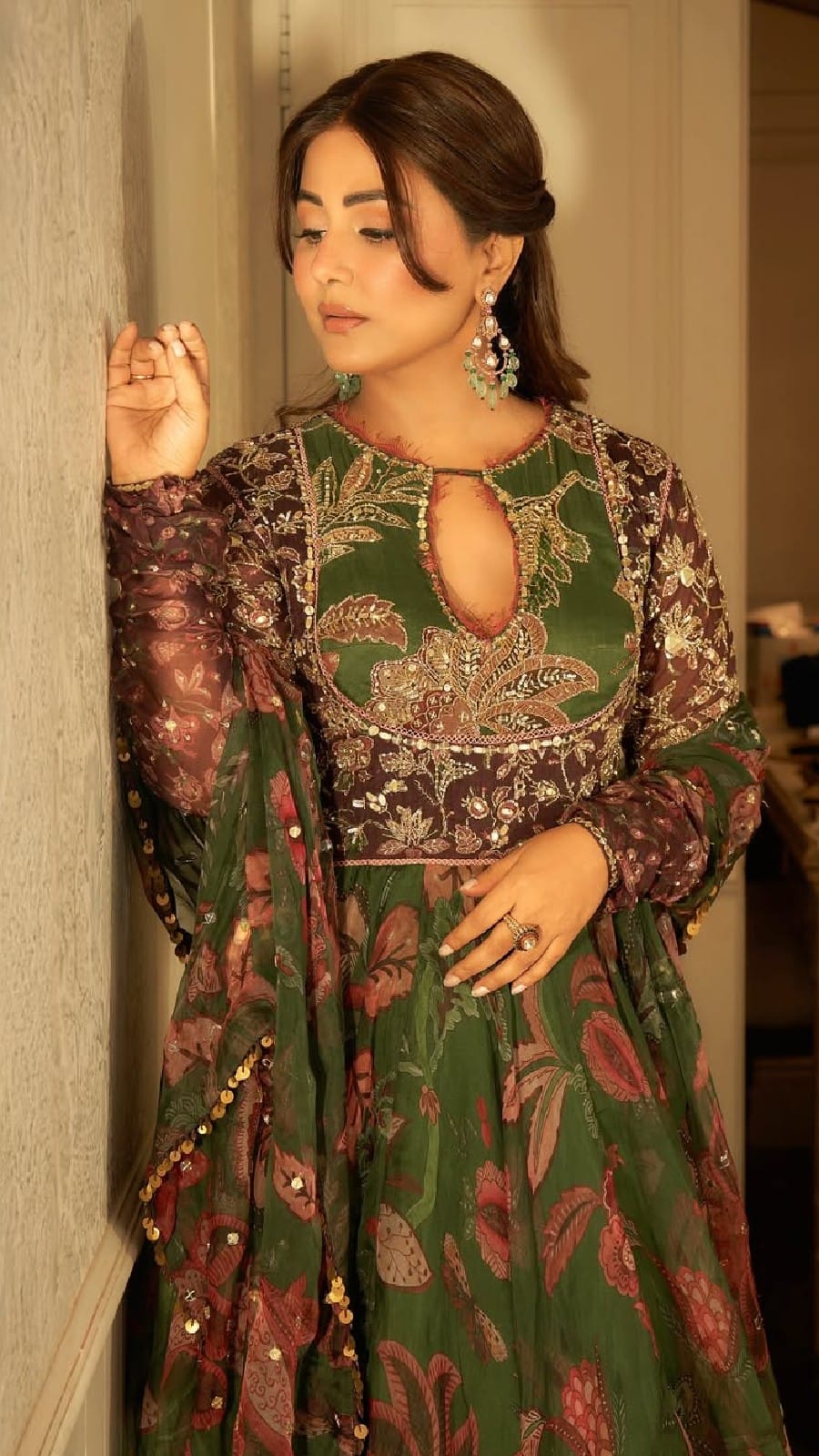 hina khan green dress Hina Khan (@realhinakhan) stuns in an olive-green floor-length anarkali  with red floral motifs and a translucent overlay that adds an ethereal  dimension to the silhouette. Pairing the look with delicate stone-studded  gold